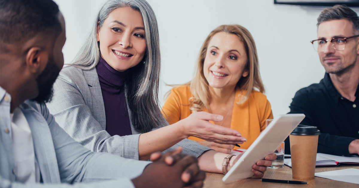 members of a digital marketing team talking around a table